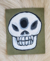 Three eyed skull with fangs